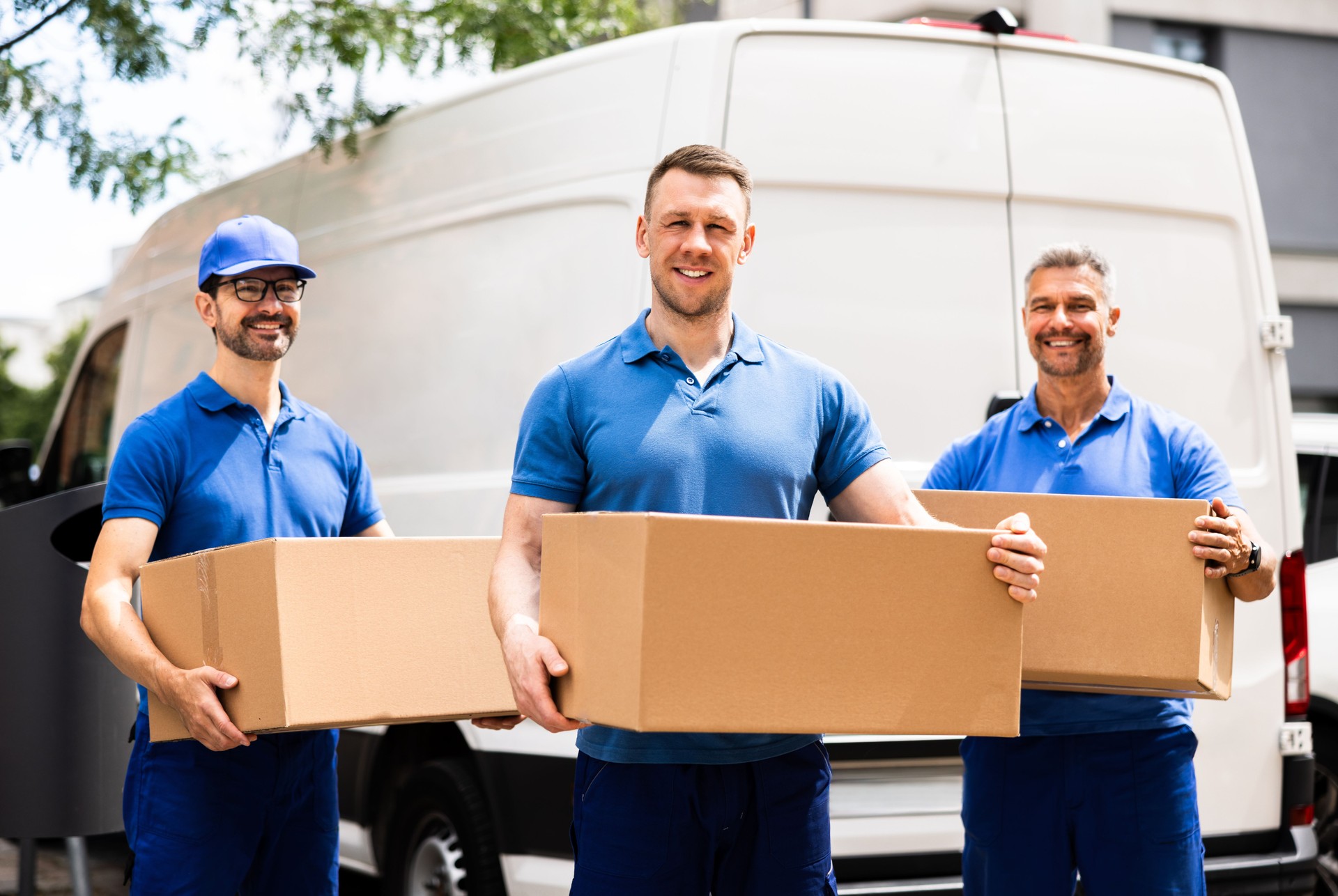 Professional Movers Loading a Van with Boxes for a House Move