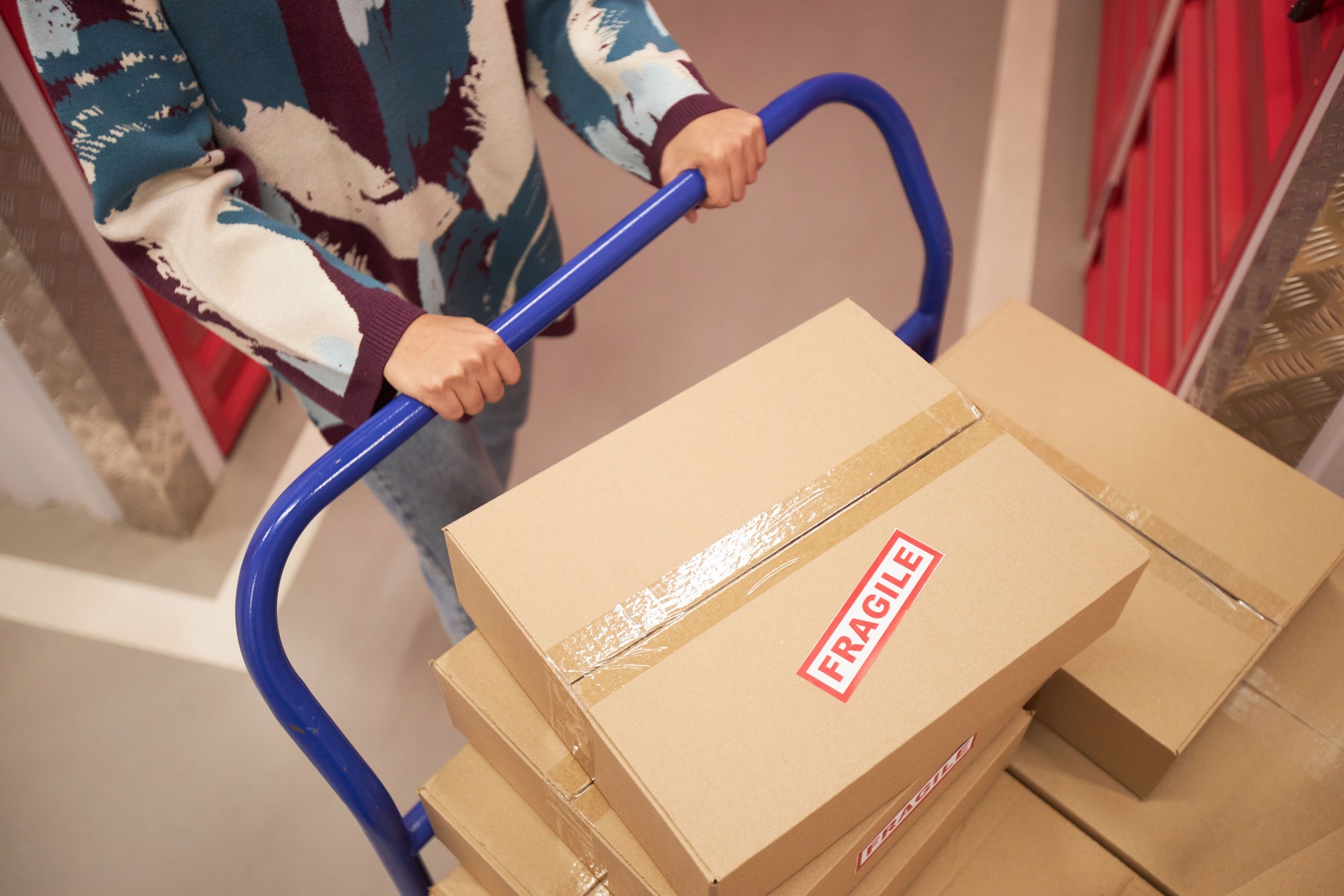 Woman Pushing Cart with Fragile Belongings